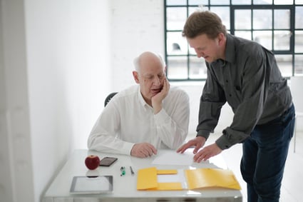 man explaining something to an elderly man